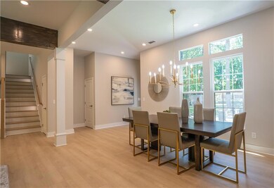 Dining area with stairway, a chandelier, recessed lighting, light wood-style floors, and baseboards
