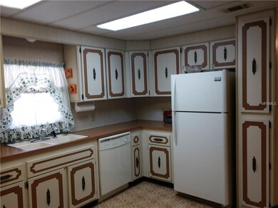 Kitchen has lots of cabinetry including a pantry. 