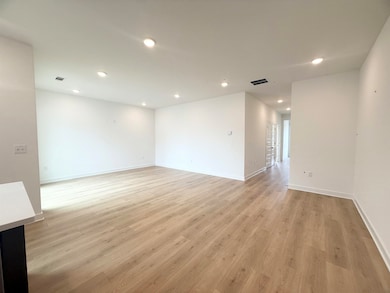 Unfurnished room featuring light wood-style floors, recessed lighting, and baseboards