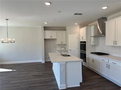 Kitchen with a center island with sink, stainless 