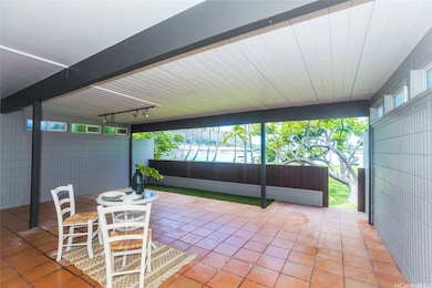 Covered Lanai to a beautiful lawn.