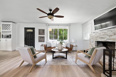 Living room featuring light wood-type flooring, c