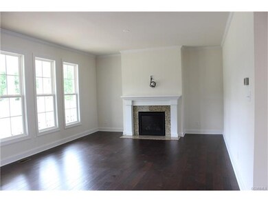 Family room with hardwood floors and fireplace. Ac