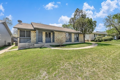 Ranch-style house featuring brick siding, a front