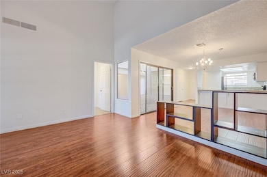 Empty room featuring a chandelier and wood finishe