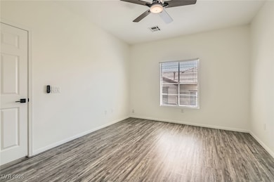 Bedroom with wood finished floors, ceiling fan, an