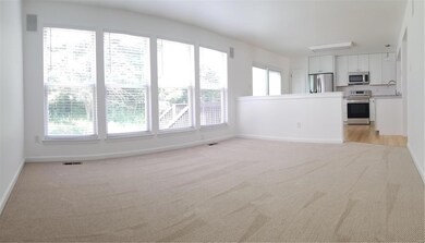 Family room with new carpeting and new window trea