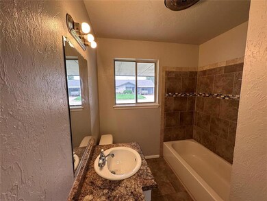 Full bathroom with tile flooring, tiled shower / b