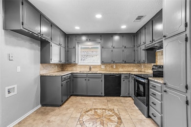Kitchen featuring gray cabinetry, light tile patterned floors, light stone counters, stainless steel electric range, and recessed lighting