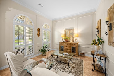 This elegant living room features large arched win