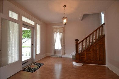 Grand foyer has plenty of room for furniture and w