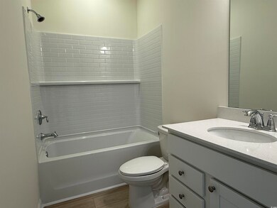 Full bath with toilet, vanity, shower / tub combination, and wood finished floors