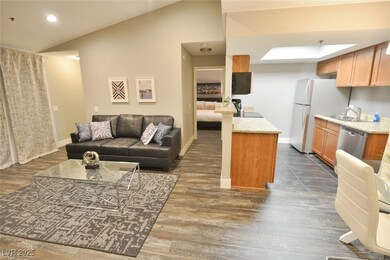 Living area with dark wood-style flooring, baseboa