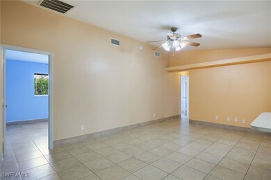 Tiled living room featuring lofted ceiling and cei