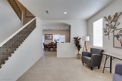 Sitting room featuring arched walkways, stairway,