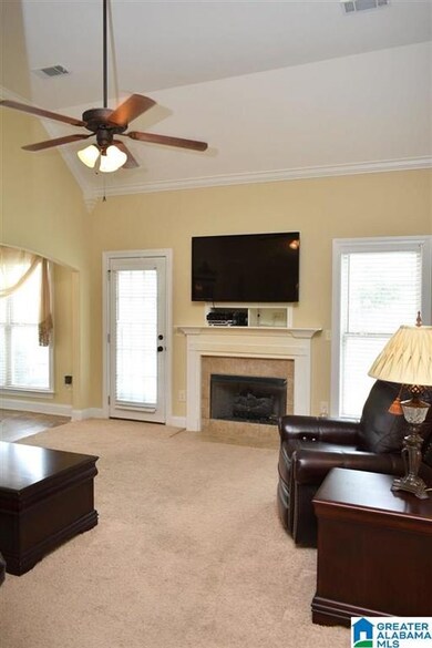 Enjoy this cozy great room with carpeting, gas fir