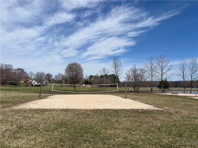 View of community featuring a lawn and volleyball