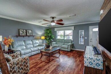 Gleaming floors, modern paint, & crown molding welcome you in to the living room.