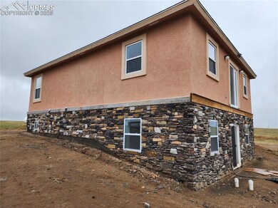 View of property exterior with stone siding and stucco siding