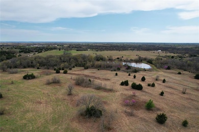 Birds eye view of property featuring a rural view