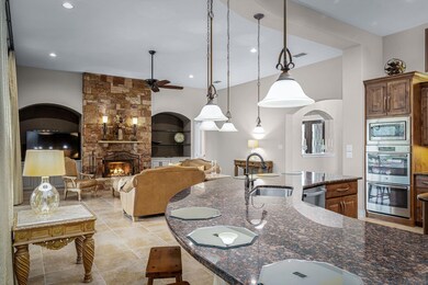 Kitchen with visible vents, dark stone counters, 