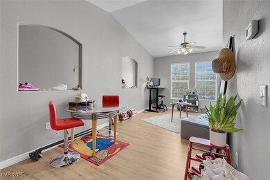 Dining room with ceiling fan, arched walkways, woo