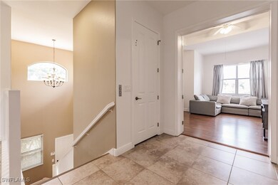 Front door and garage entry with stairs or private