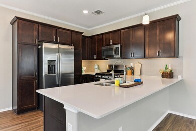 Kitchen with stainless steel appliances, a penins