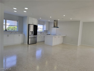 Kitchen featuring island exhaust hood, white cabin