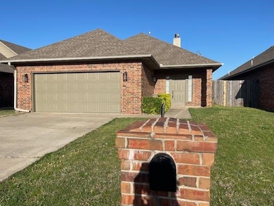 Ranch-style home with roof with shingles, driveway