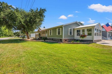 Back of property with crawl space, a sunroom, and a yard