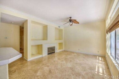 Family room boasts travertine flooring, media nich