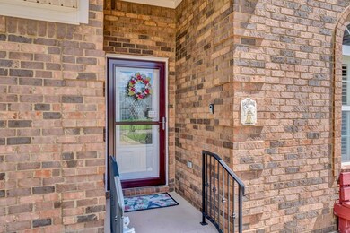 Property beautiful entrance with wrought iron railing and brick exterior