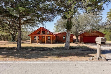 View of front of house featuring dirt driveway, co