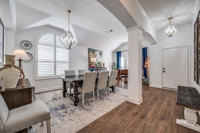 Enter on beautiful wood floors accented with tall 