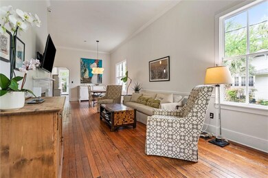 Living area featuring baseboards, ornamental moldi