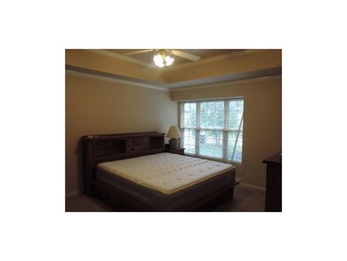 First floor master bedroom with raised ceiling and