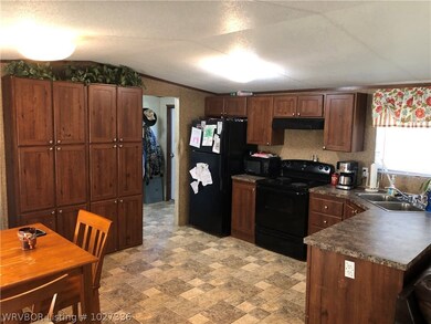 kitchen with pantry & door to utility and back doo