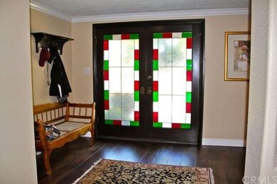 Gracious entry with wood floors, crown molding, an