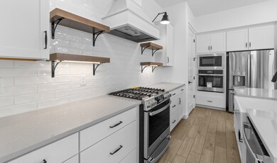 Kitchen with floating shelves & ceramic tile backsplash