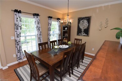 Dining room with large windows and beautiful pendant fixture.