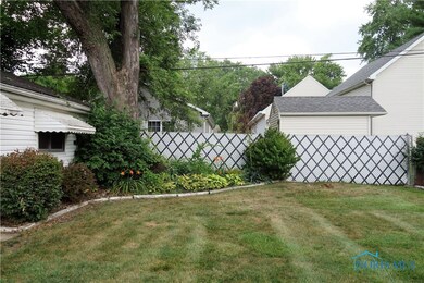 Fenced Backyard with Nice Lush Flower Bed