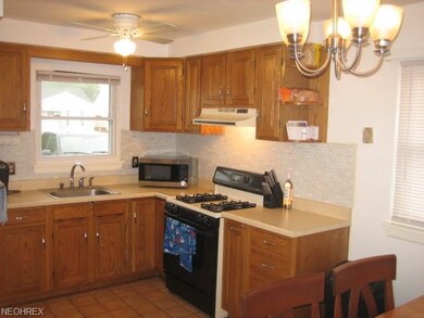 Kitchen with Ceramic Tile, new Glass Back Splash, new Hardware and new Window Treatment.