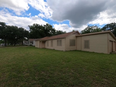 Back of property with a yard
