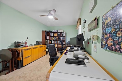 Office area featuring carpet floors and ceiling fan