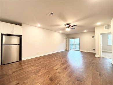 Empty room featuring visible vents, wood finished 