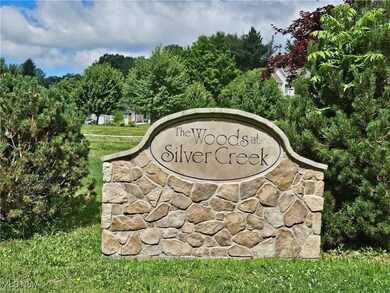 Community / neighborhood sign featuring a lawn