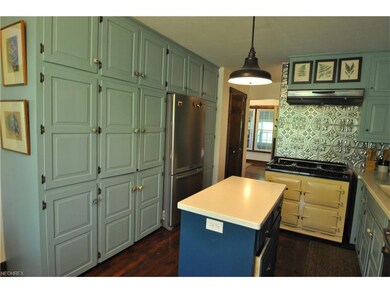The quaint kitchen offers a wall of cabinets for g