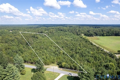 Aerial view of property's location with a forest and property parcel outlined