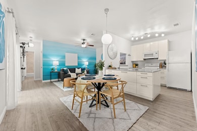 Dining area with light wood finished floors, a ce
